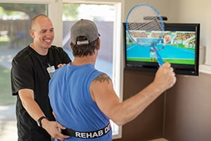 A man doing rehab with a patient