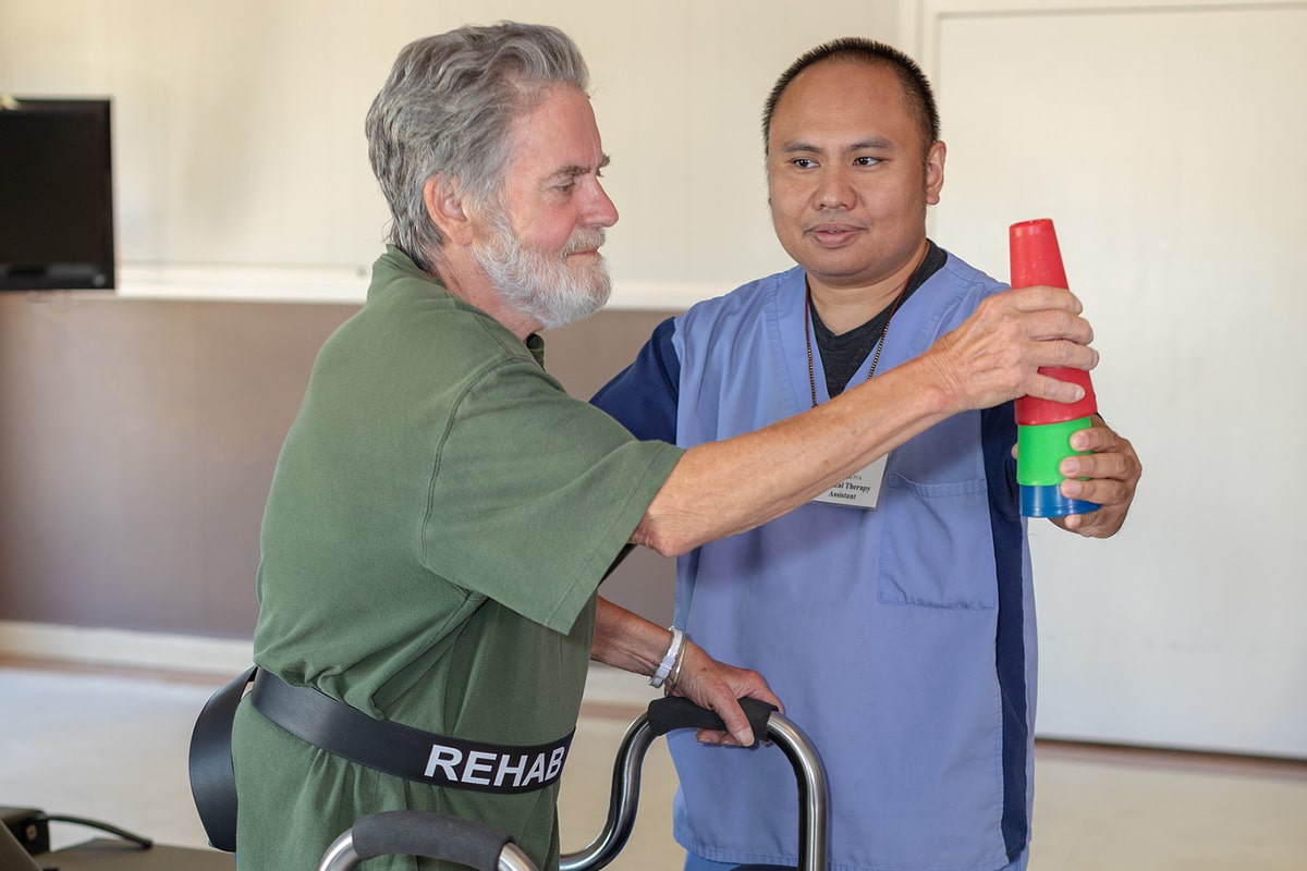 An elderly man doing rehab with a therapist at Marysville Post Acute