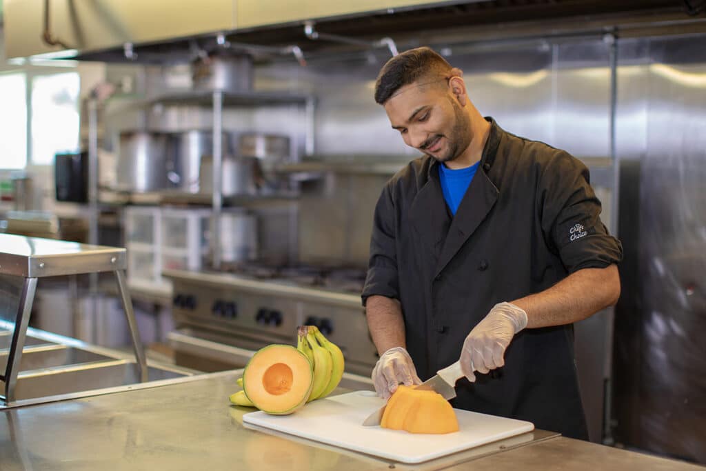 A chef cutting fruits at Marysville Post Acute