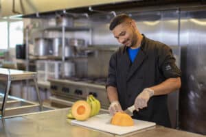 A chef cutting fruits at Marysville Post Acute